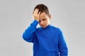 Sick boy in slue hoodie suffering from headache Royalty Free Stock Photo