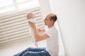 Childhood, family and fatherhood concept - proud bald father holding his newborn baby daughter in the air Royalty Free Stock Photo