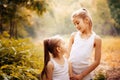 Childhood, family, friendship and people concept - two happy kids sisters hugging outdoors. Royalty Free Stock Photo