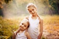 Childhood, family, friendship and people concept - two happy kids sisters hugging outdoors. Royalty Free Stock Photo