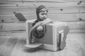 Childhood. Fantasy, imagination. Brave dreamer boy playing with a cardboard airplane Royalty Free Stock Photo