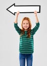 Smiling red haired girl with arrow showing to left Royalty Free Stock Photo