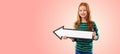 Smiling red haired girl with arrow showing to left Royalty Free Stock Photo