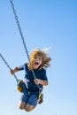 Childhood. Funny kid on swing. Little boy swinging on playground. Happy cute excited child on swing. Cute child swinging Royalty Free Stock Photo