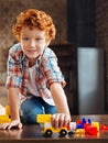 Beautiful blue eyed boy looking into camera while playing Royalty Free Stock Photo