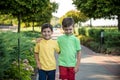 Childhood, hiking, family, friendship and people concept - two happy kids walking along forest path Royalty Free Stock Photo