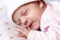 Childhood, illness, colic, bloating, motherhood, health concepts - Close up restless, worried sad newborn baby girl in hat sleeps Royalty Free Stock Photo