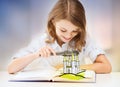 Girl with magnifier reading fairytale book