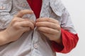 Childhood independence concept ,little boy buttoning on shirt, fastening his buttons , isolated on white gray background Royalty Free Stock Photo