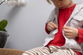 Childhood independence concept ,little boy buttoning on shirt, fastening his buttons , on white gray background. The Royalty Free Stock Photo