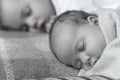 Childhood, infancy, family, sleep, rest, love concept - black white close up of two children, newborn baby and girl Royalty Free Stock Photo