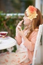 Childhood innocence. A little girl sitting outside having a tea party. Royalty Free Stock Photo