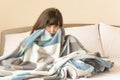 Afraid child girl lying in bed, awakened by nightmare, peeking from blanket. Royalty Free Stock Photo