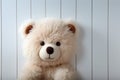 Childhood joy Cute teddy bear hides behind white wooden door Royalty Free Stock Photo