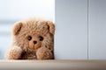 Childhood joy Cute teddy bear hides behind white wooden door