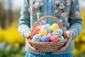 Childhood joy small hands holding easter basket with colorful eggs and traditional easter bread