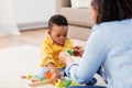 Mother and baby playing with toy blocks at home Royalty Free Stock Photo