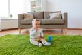 Baby boy on floor and eating rice cracker at home Royalty Free Stock Photo