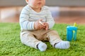 Baby boy on floor and eating rice cracker at home Royalty Free Stock Photo