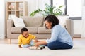 Mother and baby playing with toy blocks at home Royalty Free Stock Photo