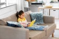 Happy smiling little girl reading book at home Royalty Free Stock Photo