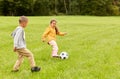 little children with ball playing soccer at park Royalty Free Stock Photo