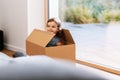 little baby girl sitting in cardboard box at home Royalty Free Stock Photo