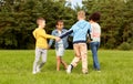 happy children playing round dance at park