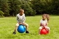 happy children bouncing on hopper balls at park Royalty Free Stock Photo