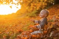 Childhood memories. Child autumn leaves background. Warm moments of autumn. Toddler boy blue eyes enjoy autumn. Small Royalty Free Stock Photo