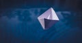 Childhood memory concept: paper origami boat on voyage in blue w Royalty Free Stock Photo