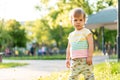 Childhood, nature, summer, parks and outdoors concept - portrait of cute blond-haired little boy in striped multi