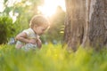 Childhood, nature, summer, parks and outdoors concept - portrait of cute blond-haired little boy in striped multi