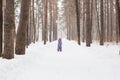 Childhood, nature and winter concept - Funny laughing toddler girl running in a beautiful snowy park Royalty Free Stock Photo