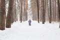 Childhood, nature and winter concept - Funny laughing toddler girl running in a beautiful snowy park Royalty Free Stock Photo