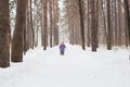 Childhood, nature and winter concept - Funny laughing toddler girl running in a beautiful snowy park Royalty Free Stock Photo