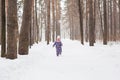 Childhood, nature and winter concept - Funny laughing toddler girl running in a beautiful snowy park Royalty Free Stock Photo