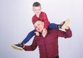 Childhood. parenting. fathers day. happy family. father and son in red checkered shirt. little boy with dad man. Serious Royalty Free Stock Photo