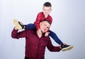 Childhood. parenting. fathers day. happy family. father and son in red checkered shirt. little boy with dad man. Serious Royalty Free Stock Photo