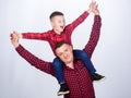 Childhood. parenting. fathers day. little boy with dad man. father and son in red checkered shirt. happy family Royalty Free Stock Photo