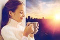 Girl with tea mug sitting at home window Royalty Free Stock Photo