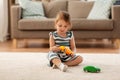 Happy baby girl playing with toy car at home Royalty Free Stock Photo