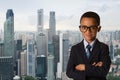 Childhood and people concept-little african american boy with glasses in business suit over city background. Cool confident smile