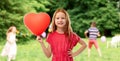 Smiling red haired girl with heart shaped balloon Royalty Free Stock Photo