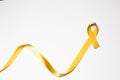 childhood ribbon, gold ribbon as symbol of childhood cancer awareness isolated on white background Royalty Free Stock Photo