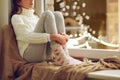 Sad girl sitting at home window on christmas Royalty Free Stock Photo