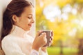 Girl with tea mug sitting at home window in autumn Royalty Free Stock Photo