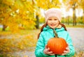 Happy redhead girl with pumpkin at autumn park Royalty Free Stock Photo