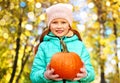 Happy redhead girl with pumpkin at autumn park Royalty Free Stock Photo