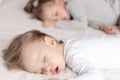 Childhood, sleep, relaxation, family, lifestyle concept - two young children 2 and 3 years old dressed in white and Royalty Free Stock Photo